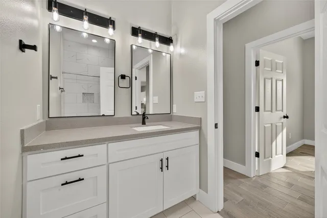 a bathroom with a double vanity sink and mirror