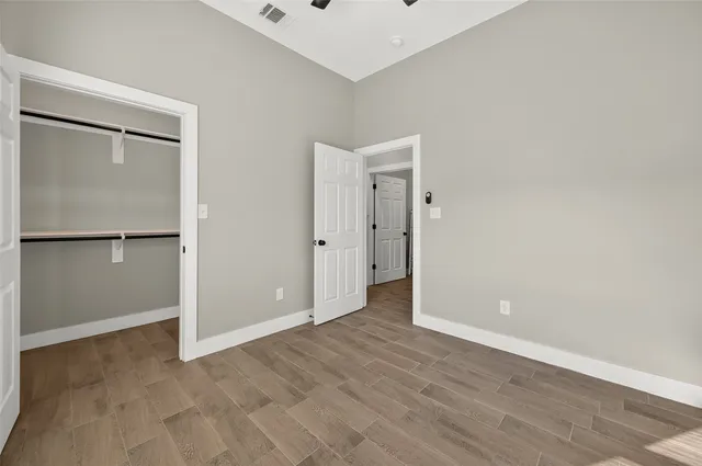 a view of a room with wooden floor