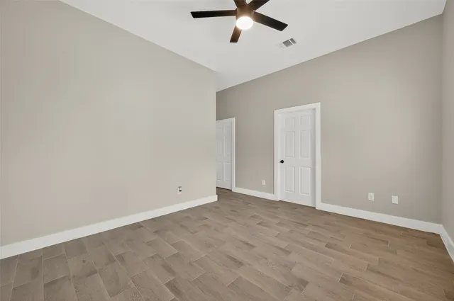 a view of a room with a ceiling fan
