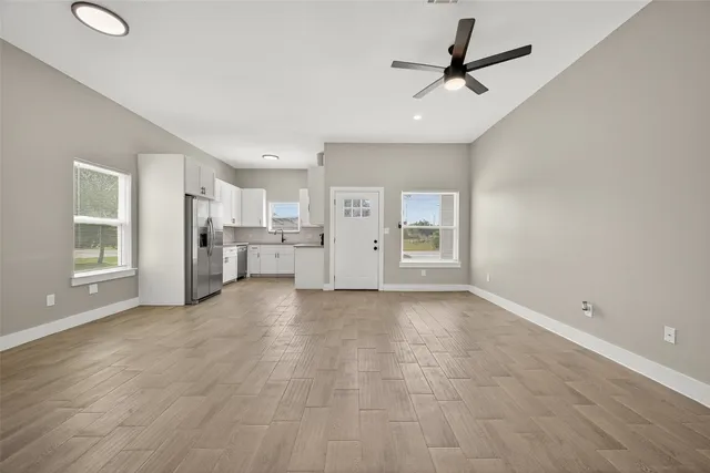 a view of a kitchen with a sink and a refrigerator