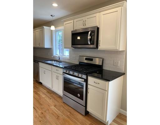 236 Prentice Street Springfield, MA 01104 - Photo 4 of 28 a kitchen with stainless steel appliances granite countertop a stove a microwave and a sink