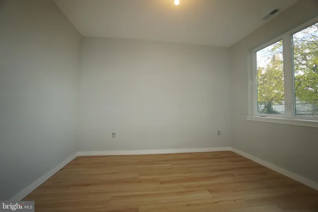 wooden floor and window in an empty room