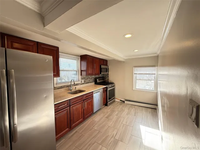 a kitchen with stainless steel appliances granite countertop a refrigerator a sink dishwasher a stove and a refrigerator with wooden floor