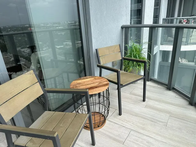 a balcony with table and chairs