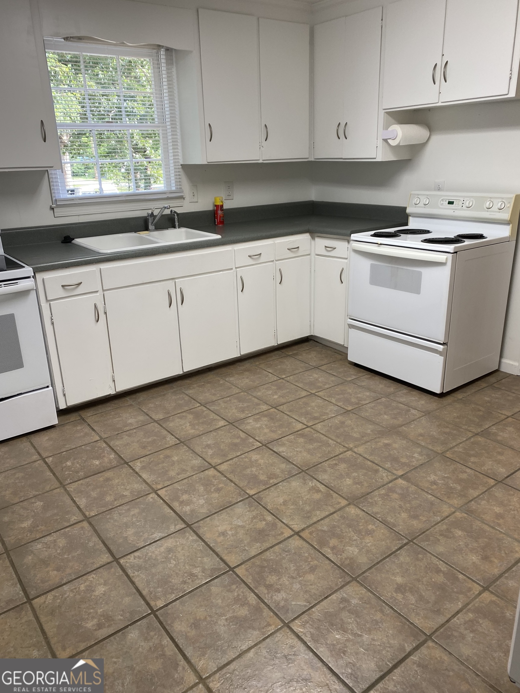 164 Glenn Carrie Road Hull, GA 30646 - Photo 17 of 43 a kitchen with stainless steel appliances a sink window and cabinets