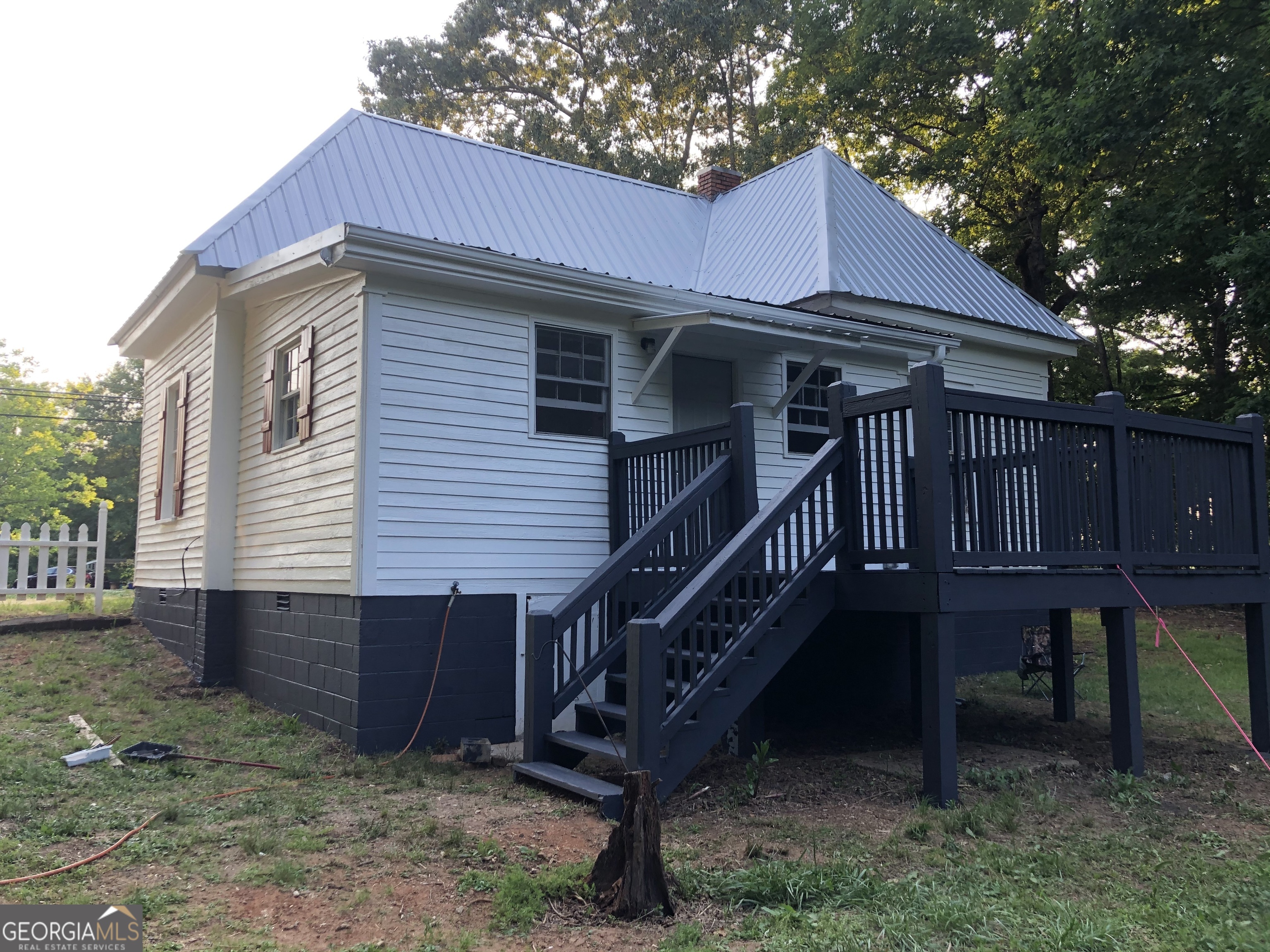 164 Glenn Carrie Road Hull, GA 30646 - Photo 2 of 43 a front view of a house with wooden deck and furniture