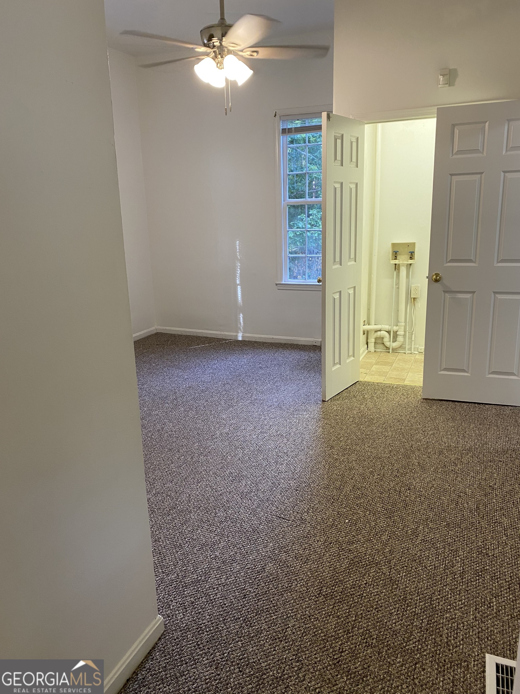 164 Glenn Carrie Road Hull, GA 30646 - Photo 21 of 43 an empty room with windows and cabinet