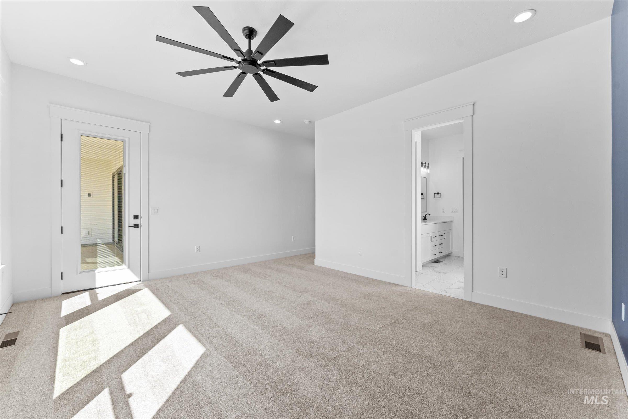 26219 Reed Lane Wilder, ID 83676 - Photo 13 of 35 Unfurnished bedroom with ensuite bath, light carpet, ceiling fan, and recessed lighting
