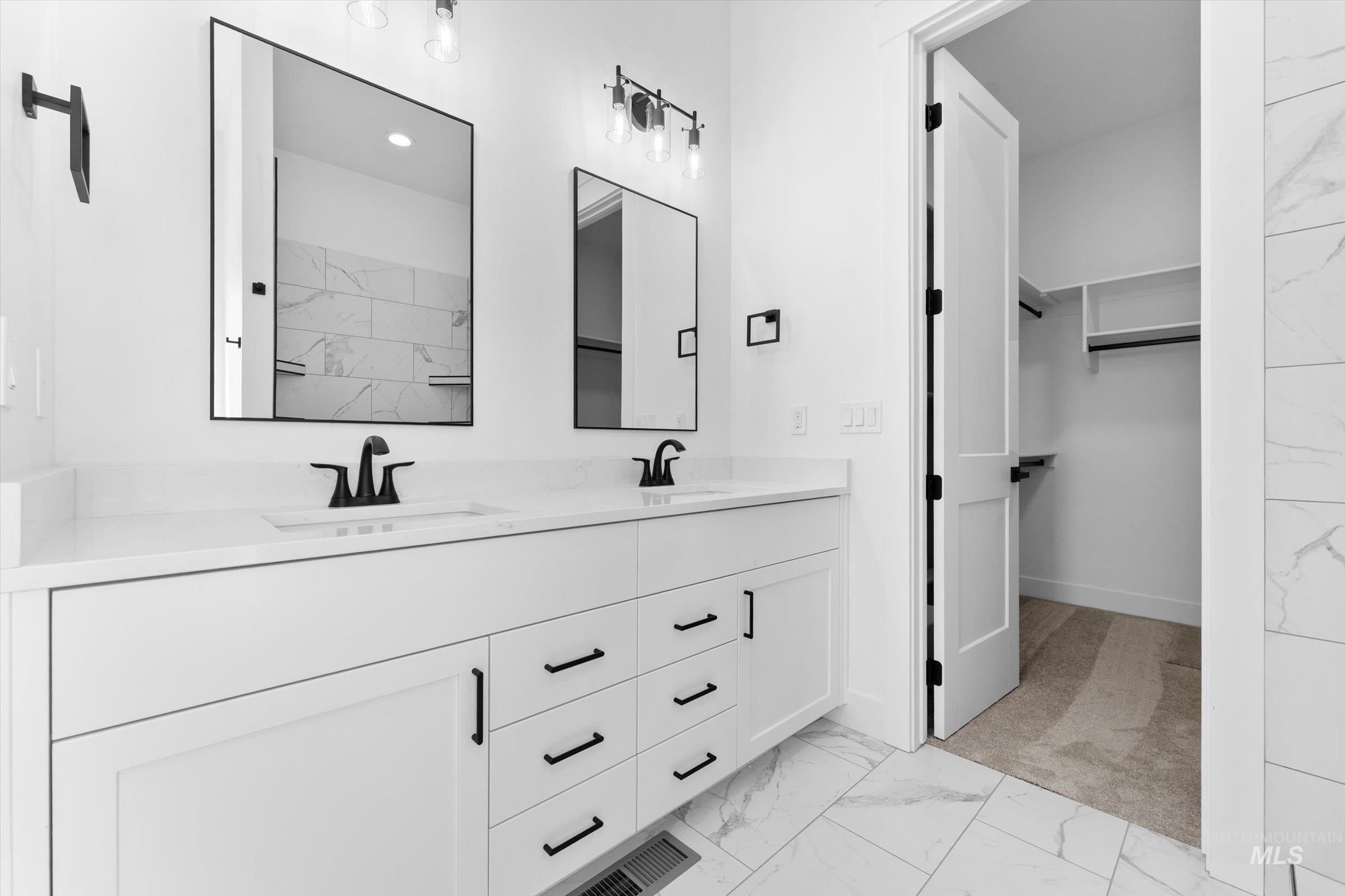 26219 Reed Lane Wilder, ID 83676 - Photo 16 of 35 Full bath featuring light marble finish floors, double vanity, and a spacious closet