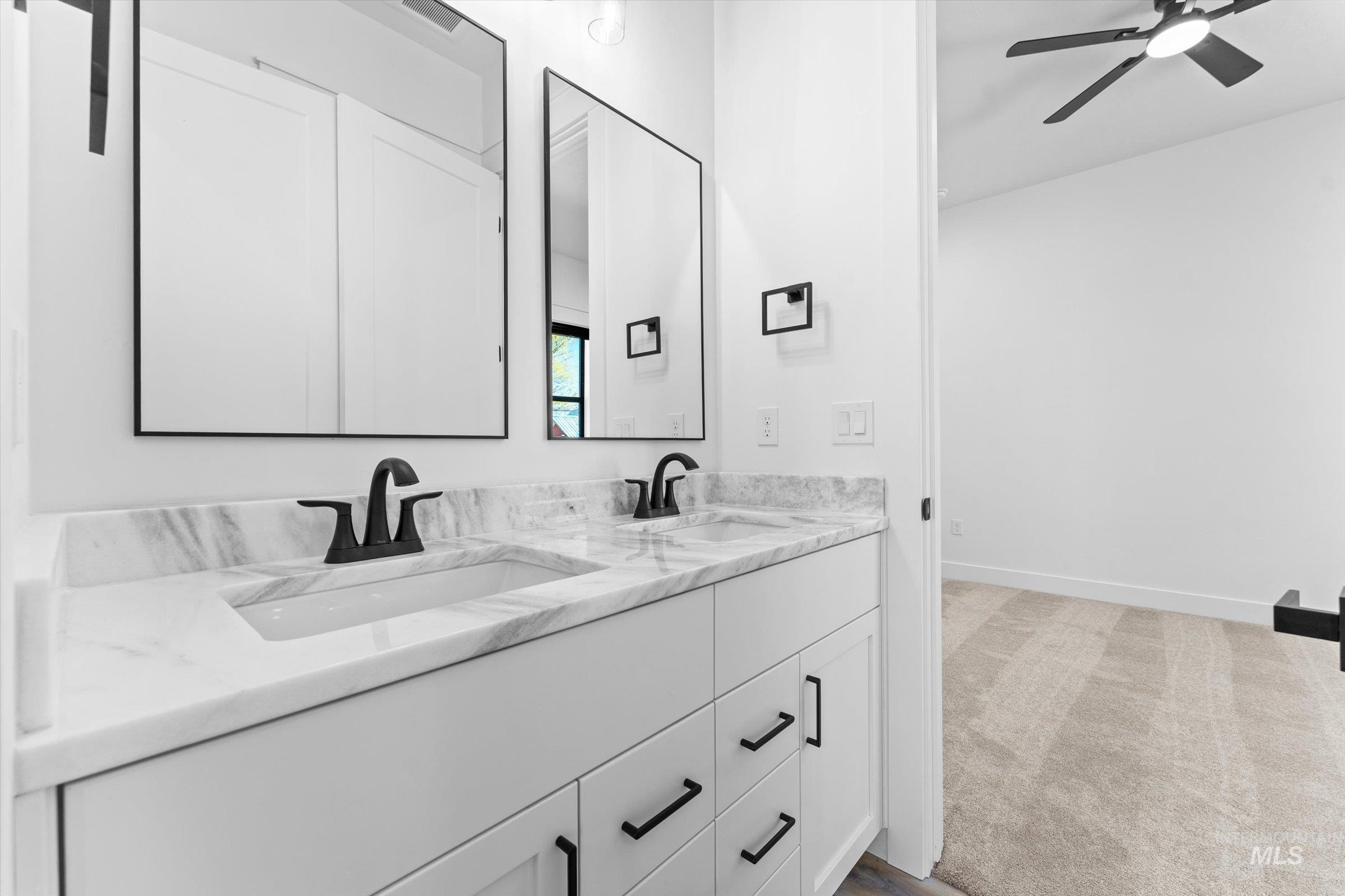 26219 Reed Lane Wilder, ID 83676 - Photo 17 of 35 Bathroom with double vanity, a ceiling fan, and light colored carpet
