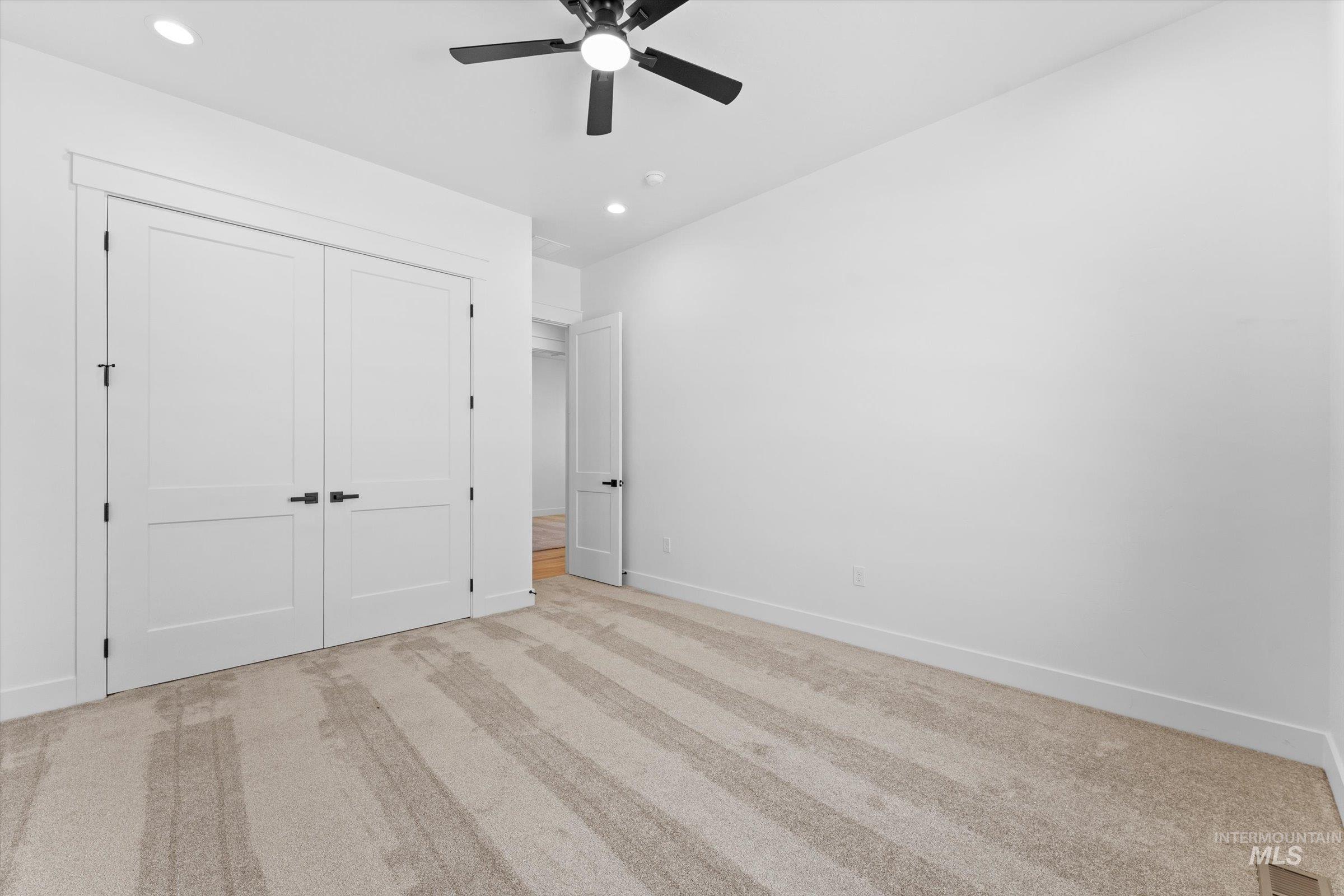 26219 Reed Lane Wilder, ID 83676 - Photo 21 of 35 Unfurnished bedroom featuring light colored carpet, ceiling fan, a closet, and recessed lighting