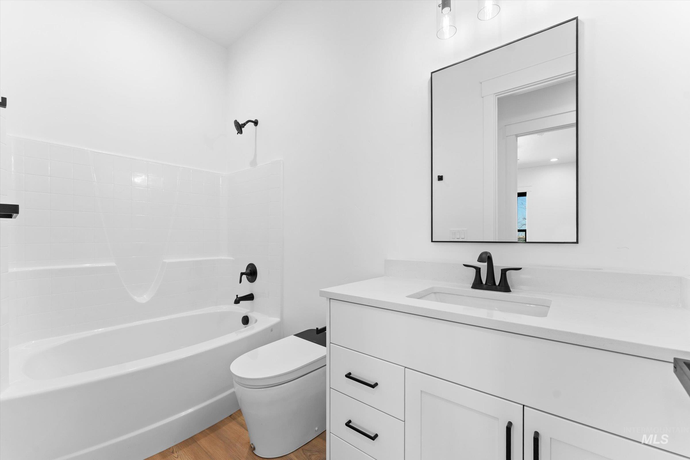 26219 Reed Lane Wilder, ID 83676 - Photo 22 of 35 Full bath featuring vanity, light wood-type flooring, and shower / tub combination