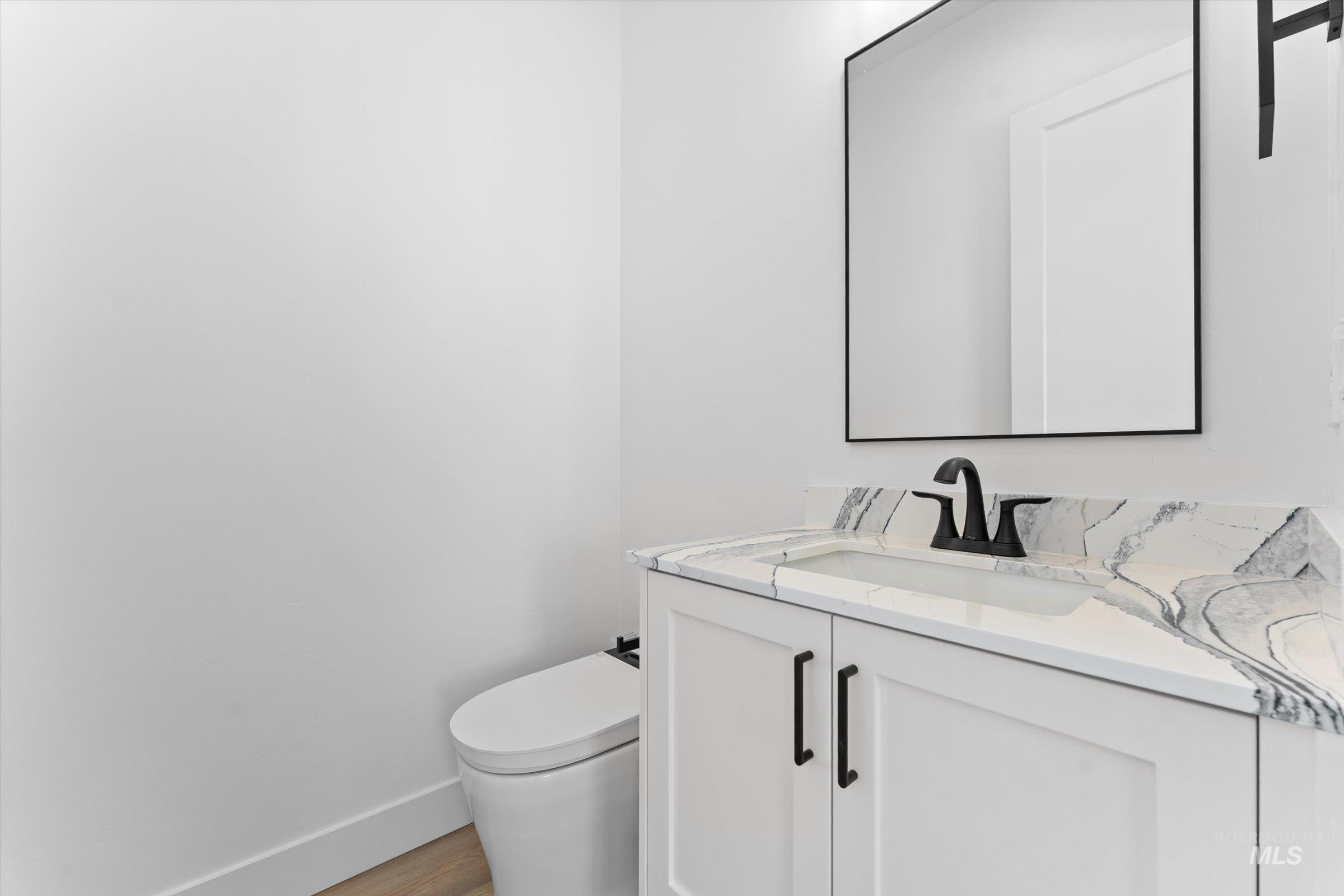 26219 Reed Lane Wilder, ID 83676 - Photo 24 of 35 Half bath with vanity and light wood-style floors
