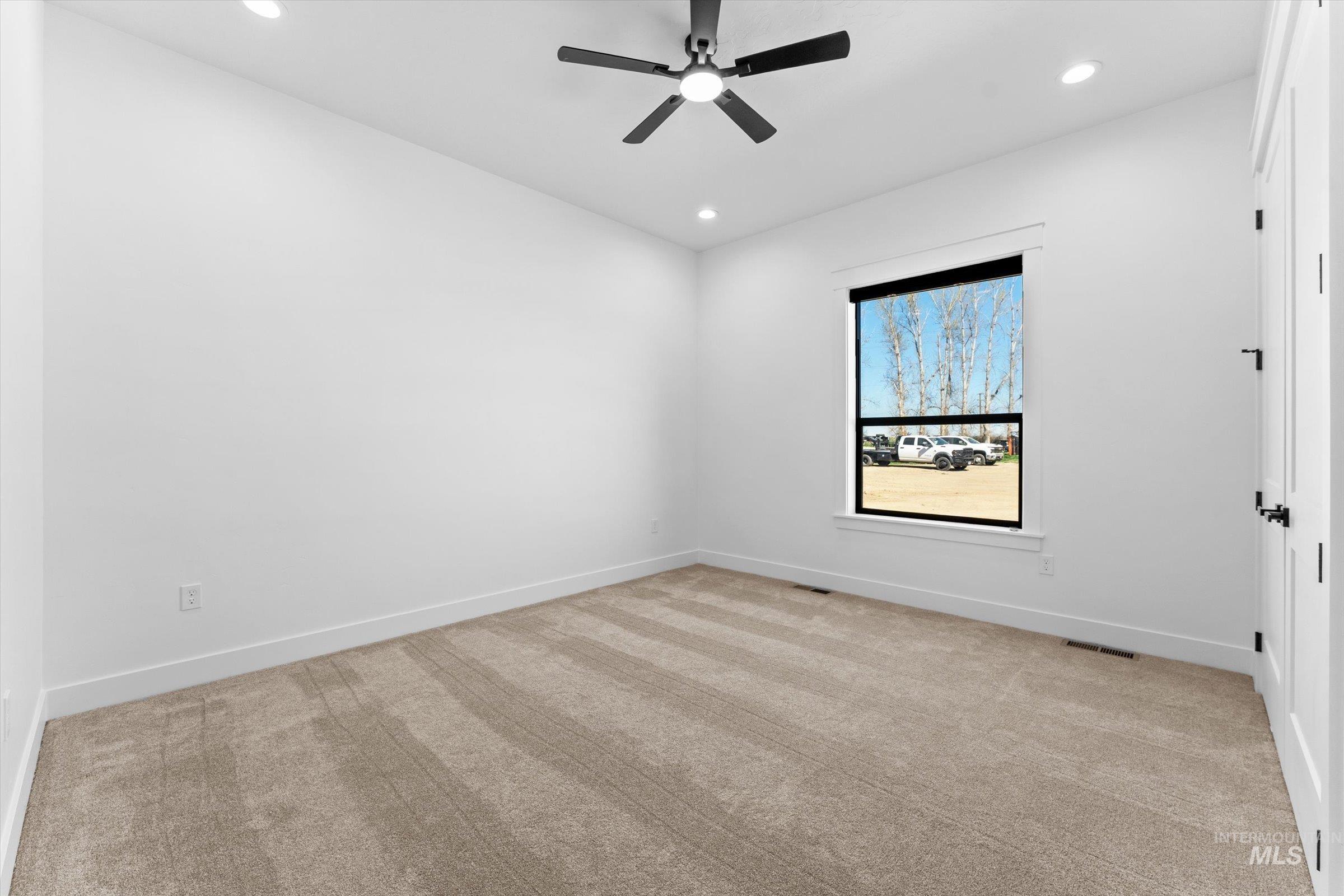 26219 Reed Lane Wilder, ID 83676 - Photo 27 of 35 Spare room featuring light colored carpet, recessed lighting, and a ceiling fan