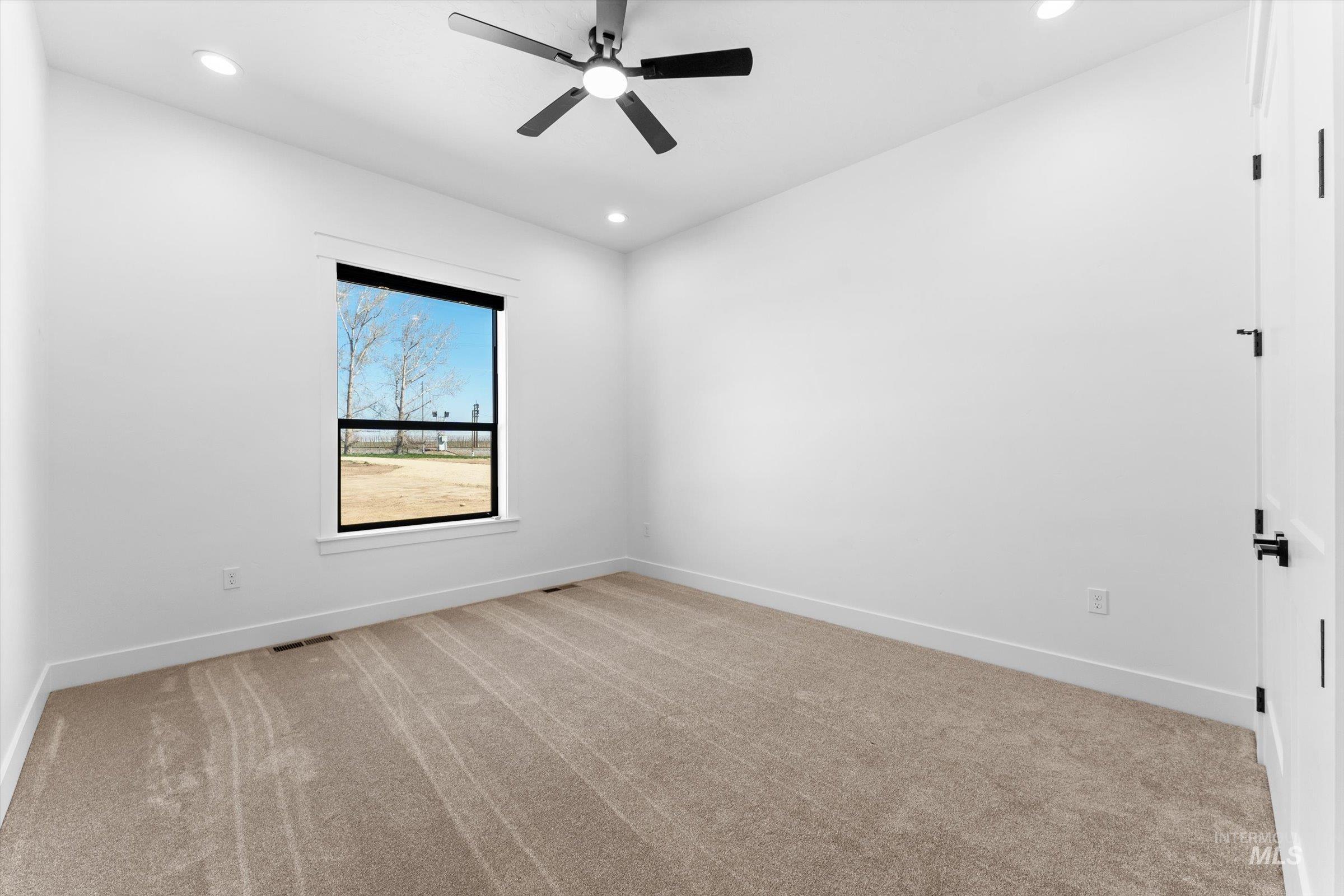 26219 Reed Lane Wilder, ID 83676 - Photo 28 of 35 Spare room featuring light colored carpet, recessed lighting, and a ceiling fan