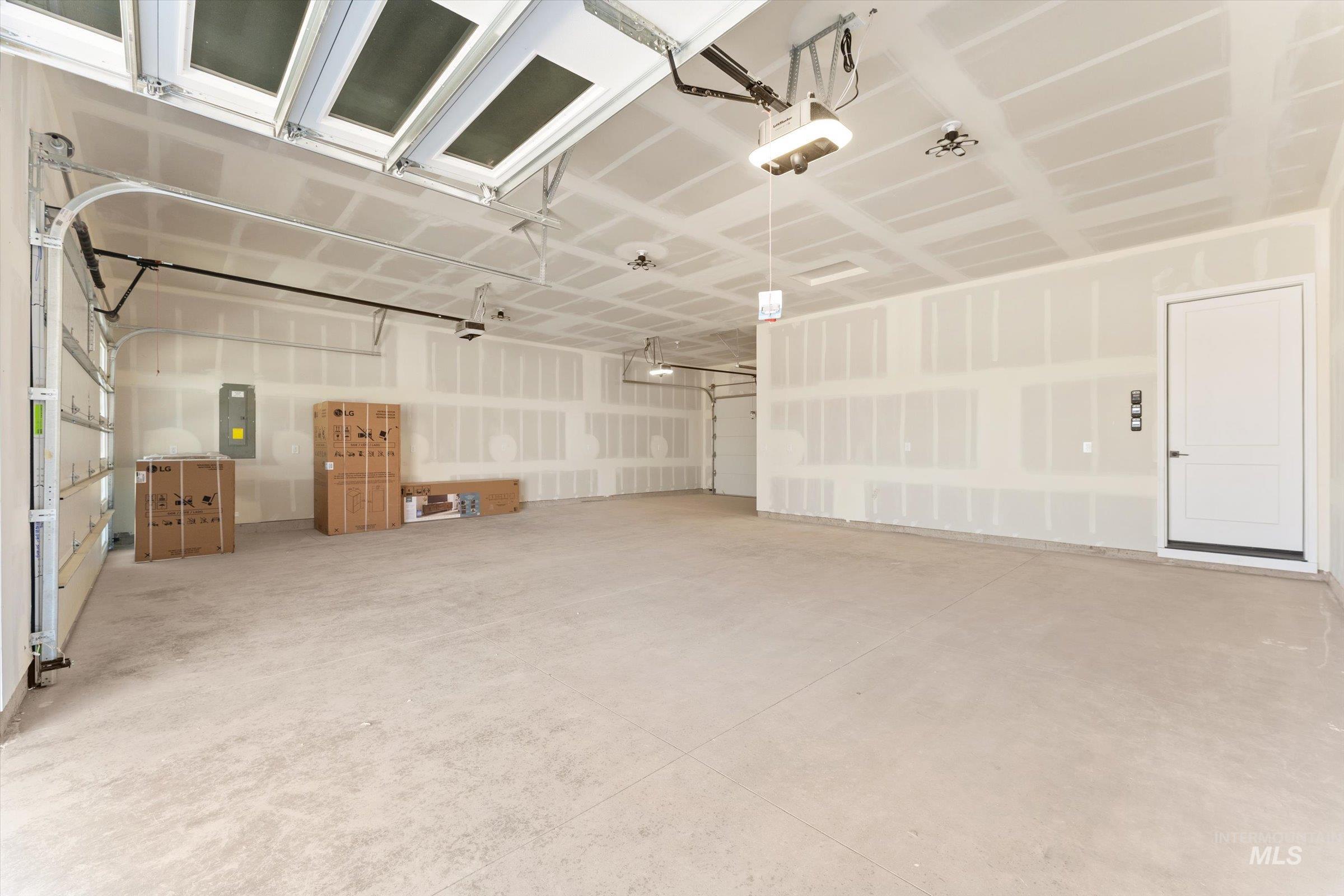 26219 Reed Lane Wilder, ID 83676 - Photo 30 of 35 Garage featuring electric panel and a garage door opener