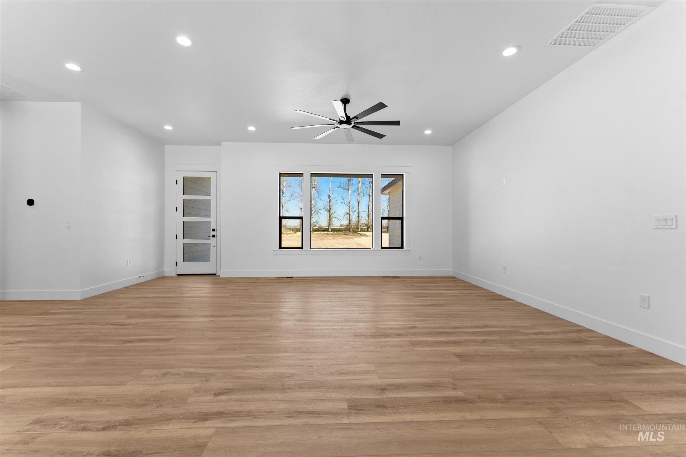 26219 Reed Lane Wilder, ID 83676 - Photo 4 of 35 Unfurnished living room featuring ceiling fan, light wood finished floors, and recessed lighting