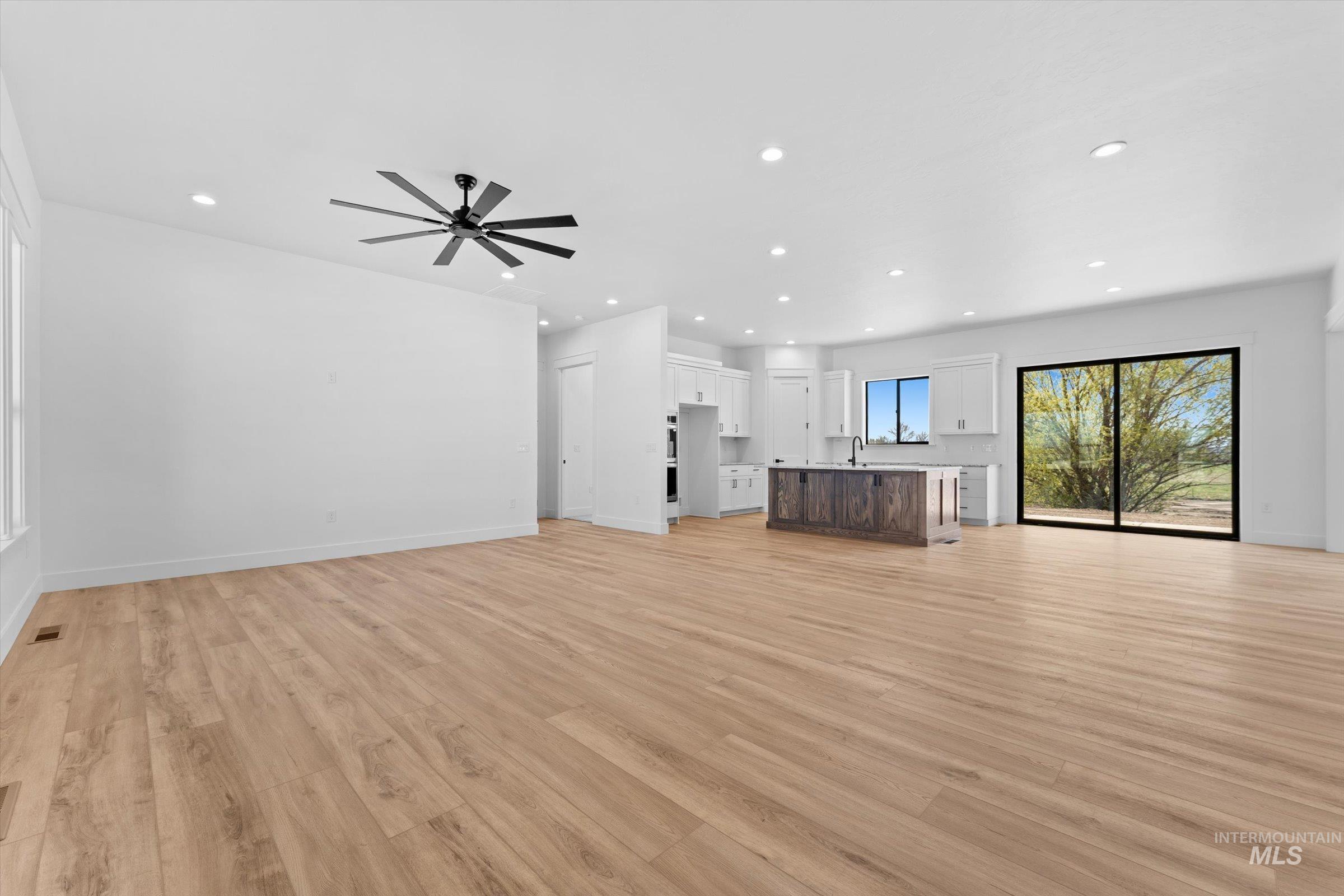 26219 Reed Lane Wilder, ID 83676 - Photo 5 of 35 Unfurnished living room with light wood-style flooring, a ceiling fan, and recessed lighting