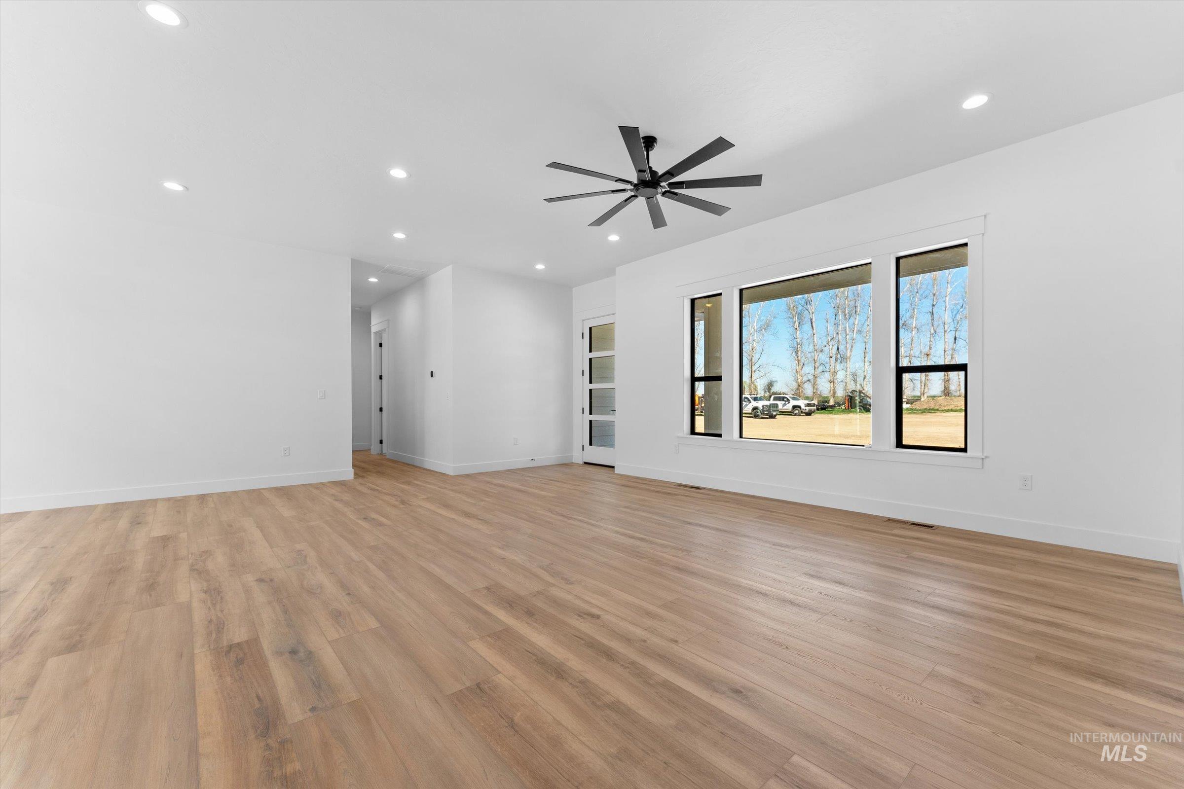 26219 Reed Lane Wilder, ID 83676 - Photo 6 of 35 Empty room featuring ceiling fan, light wood-style flooring, and recessed lighting
