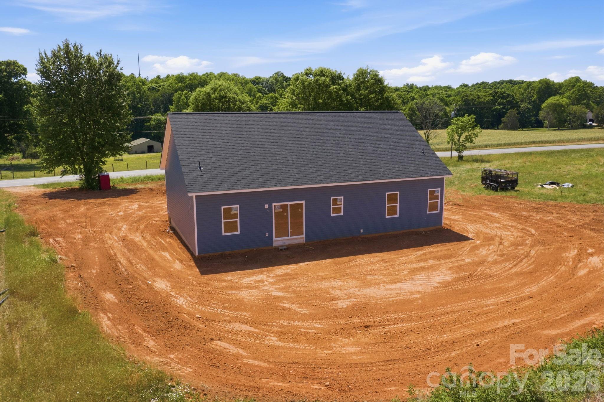 1720 Jennings Road Olin, NC 28660 - Photo 11 of 15 a view of a house with a yard and a large tree