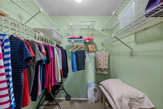 a bedroom with a bed and large windows