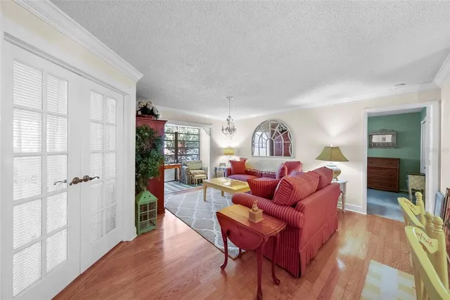 a living room with furniture and a chandelier