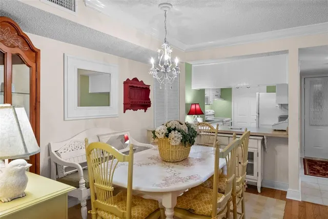 a dining room with furniture potted plants and wooden floor