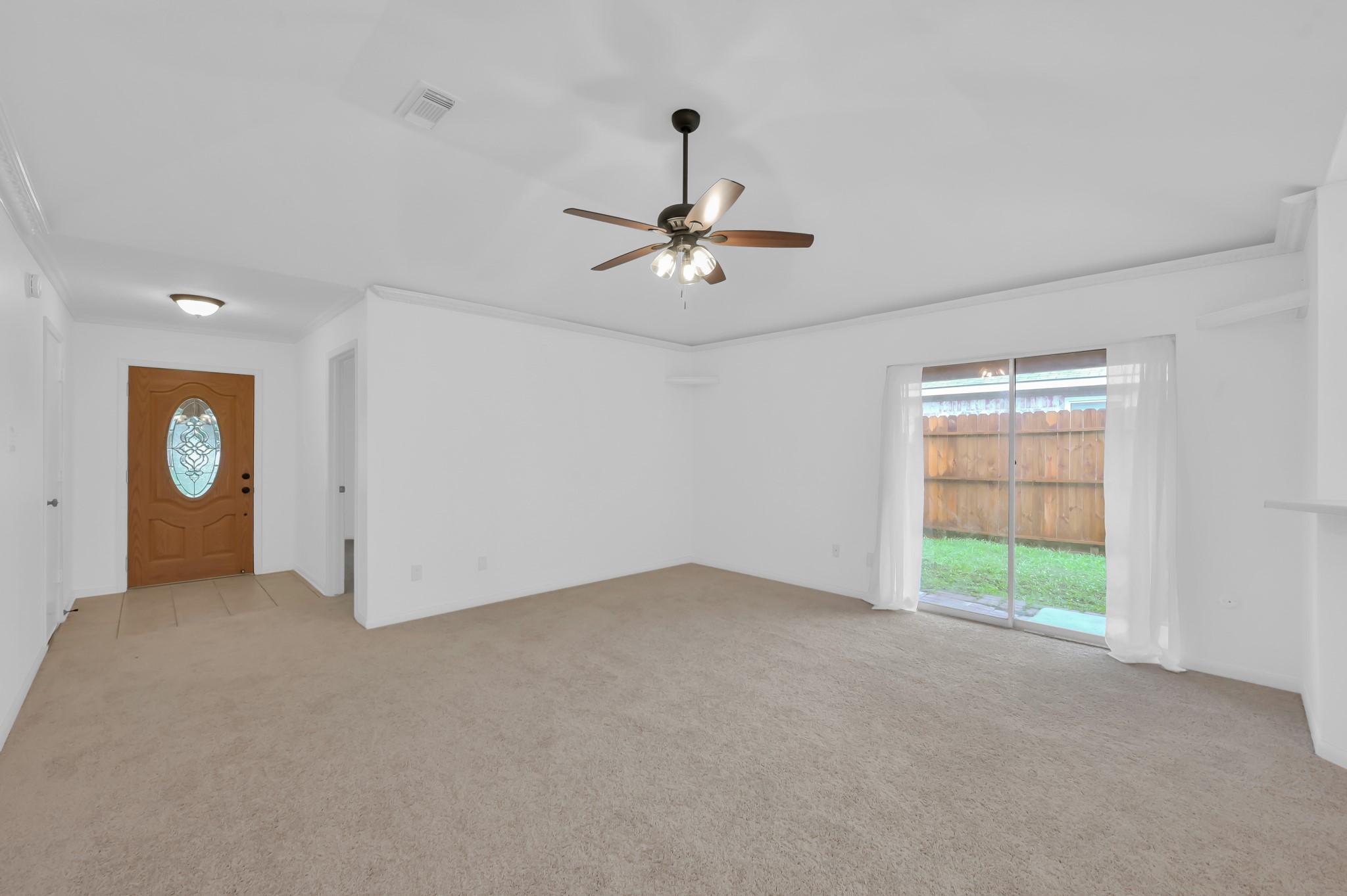 16937 Larkspur Conroe, TX 77385 - Photo 12 of 45 a view of a livingroom with a window and a ceiling fan