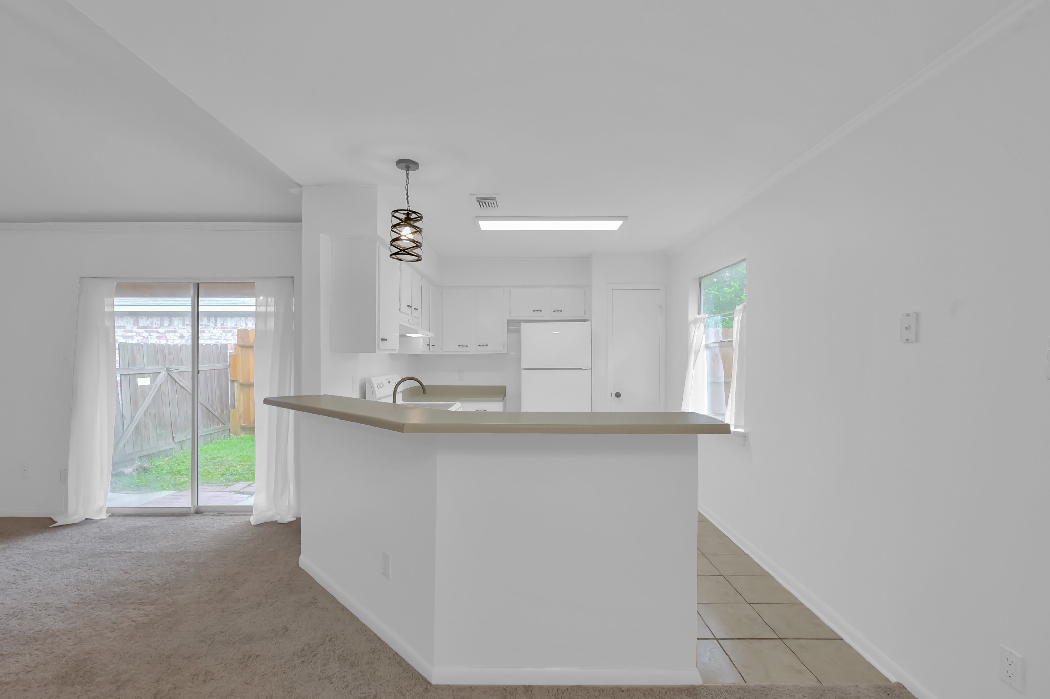 16937 Larkspur Conroe, TX 77385 - Photo 18 of 45 a kitchen with granite countertop a sink and cabinets
