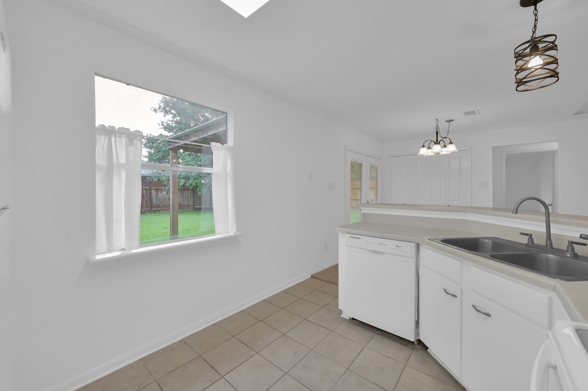 16937 Larkspur Conroe, TX 77385 - Photo 22 of 45 a kitchen with a sink and cabinets