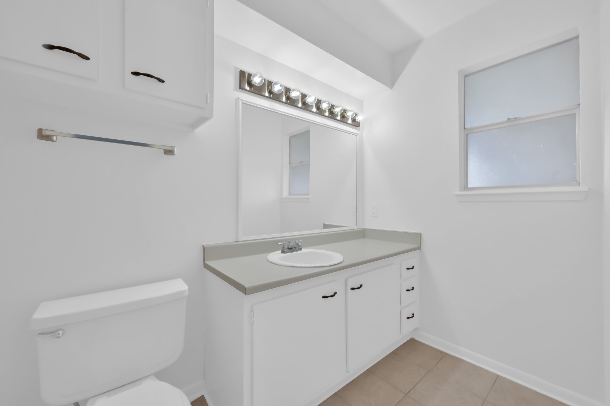 16937 Larkspur Conroe, TX 77385 - Photo 26 of 45 a bathroom with a granite countertop sink a toilet and a mirror