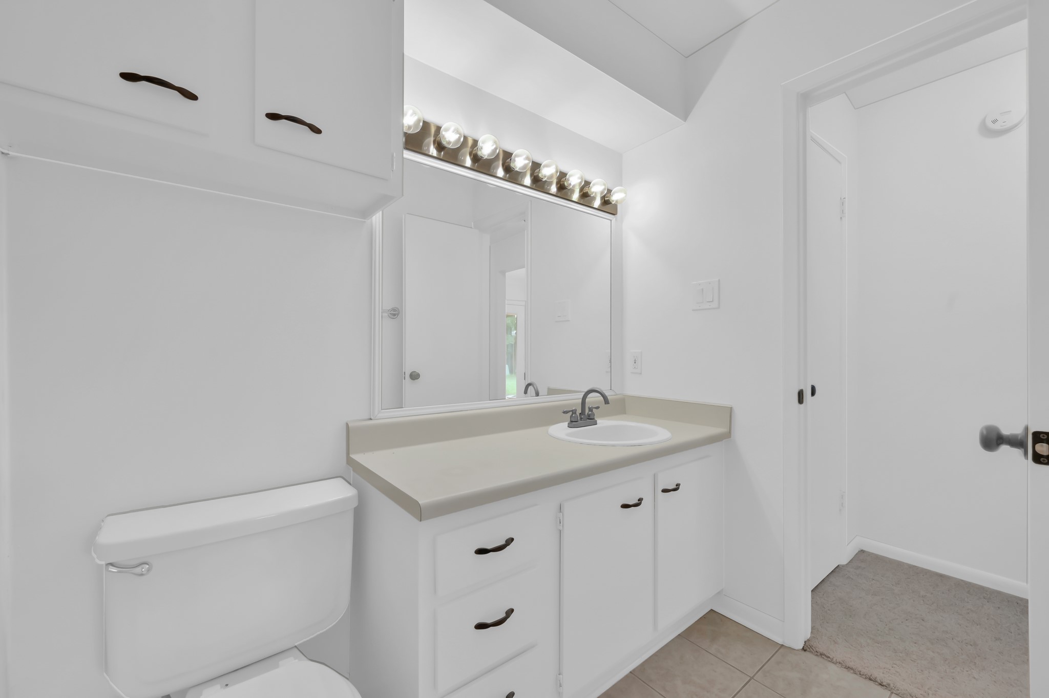 16937 Larkspur Conroe, TX 77385 - Photo 33 of 45 a bathroom with a granite countertop sink and a mirror