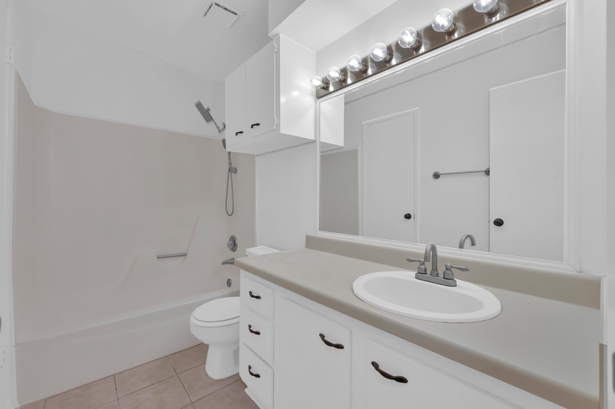 16937 Larkspur Conroe, TX 77385 - Photo 34 of 45 a bathroom with a double vanity sink mirror and toilet