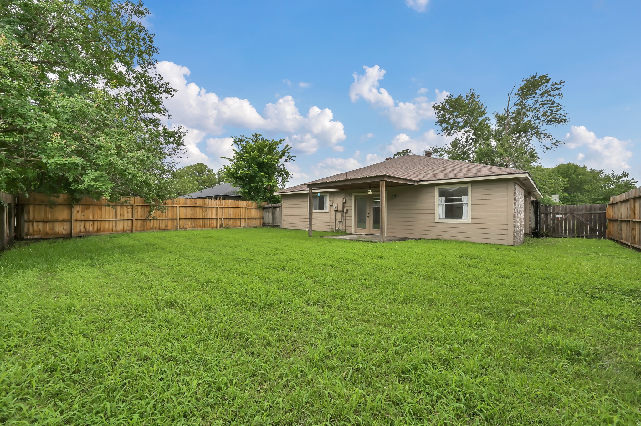 16937 Larkspur Conroe, TX 77385 - Photo 39 of 45 a view of a yard in front of a house with a large tree
