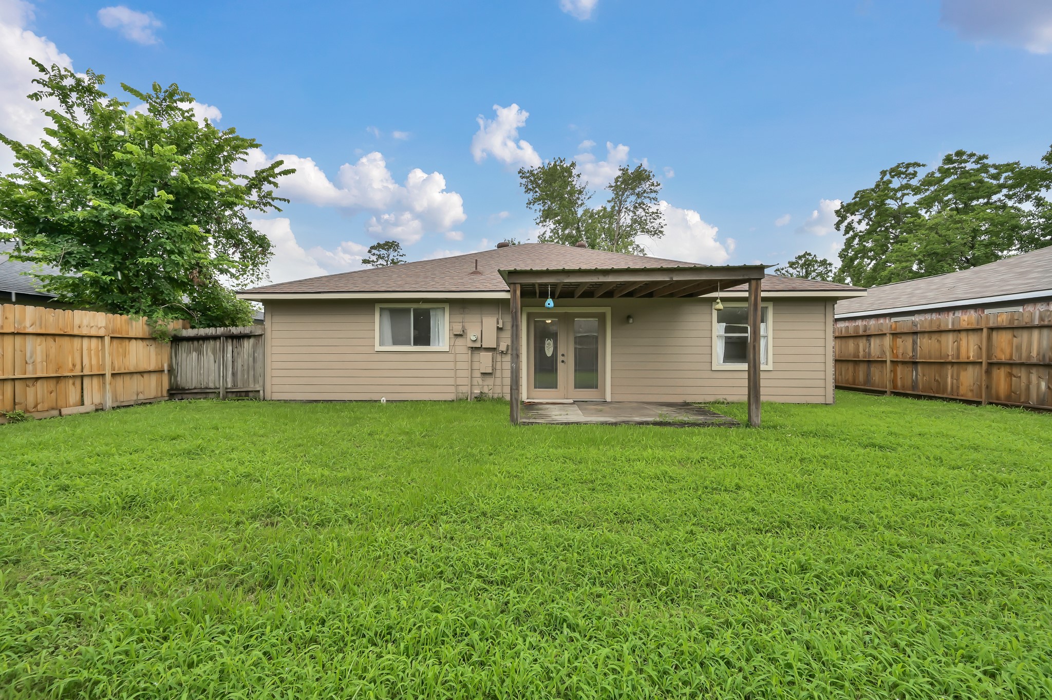 16937 Larkspur Conroe, TX 77385 - Photo 40 of 45 a view of a house with a backyard