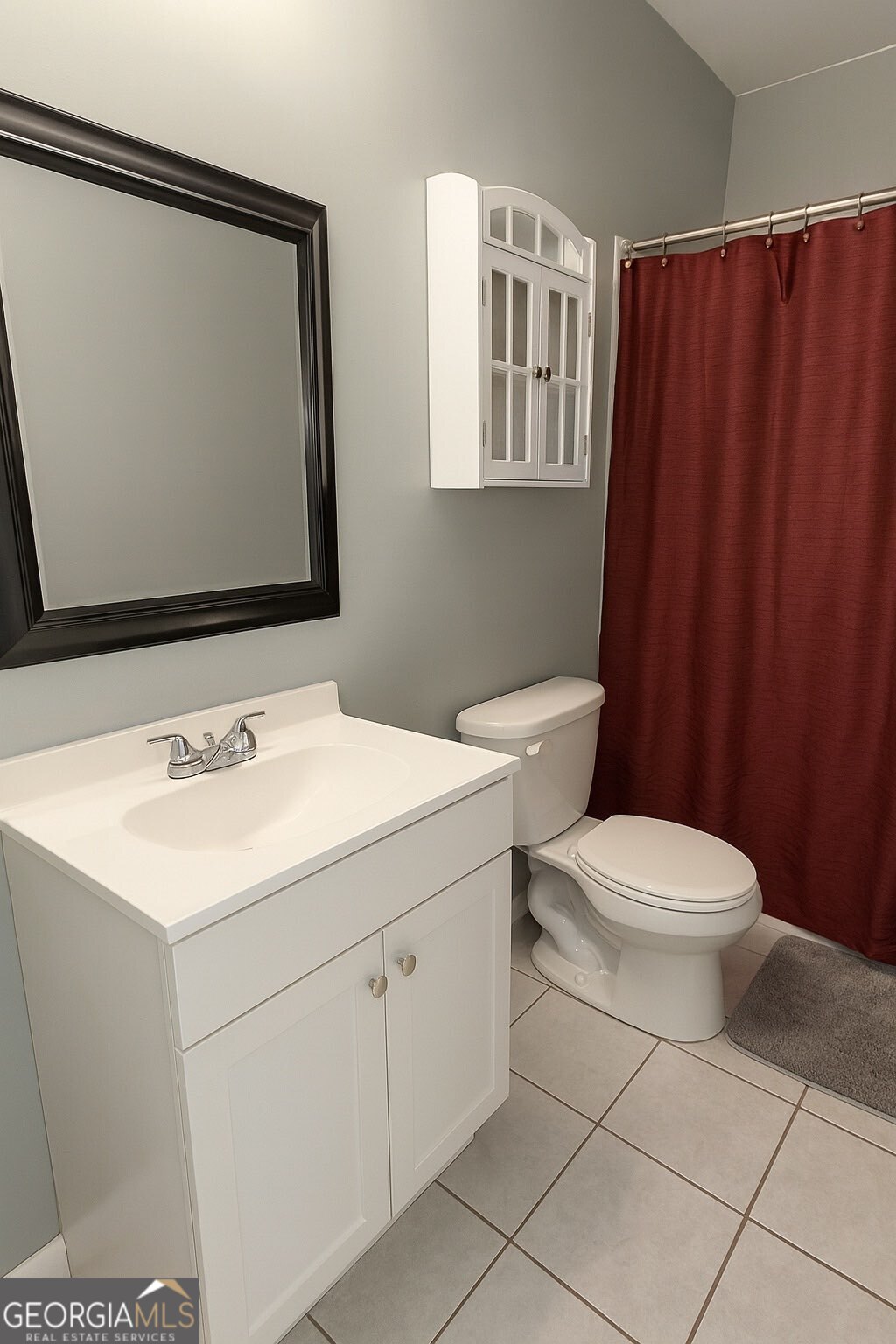 10710 Egmont Road, Unit 19 Savannah, GA 31406 - Photo 4 of 7 a bathroom with a toilet sink and mirror