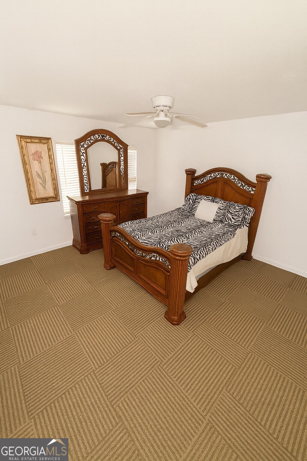10710 Egmont Road, Unit 19 Savannah, GA 31406 - Photo 5 of 7 a bedroom with a bed and dresser