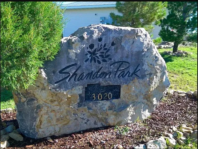 a view of a stone house with a yard