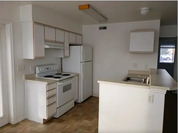 a kitchen with a stove and a refrigerator