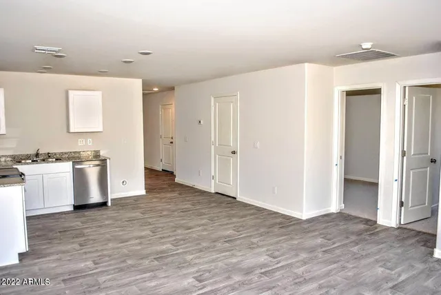 a view of kitchen with granite countertop cabinets and white appliances