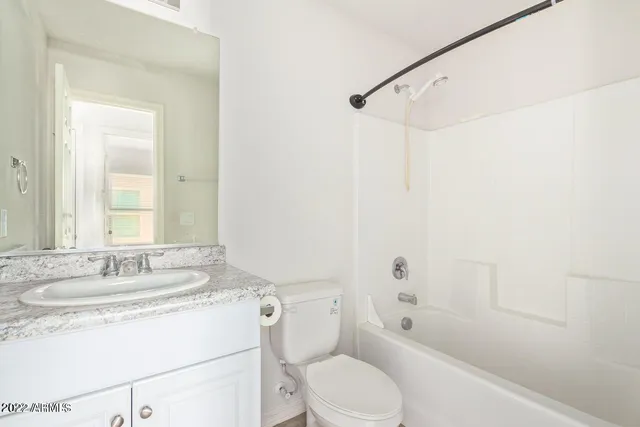 a bathroom with a sink toilet vanity and shower