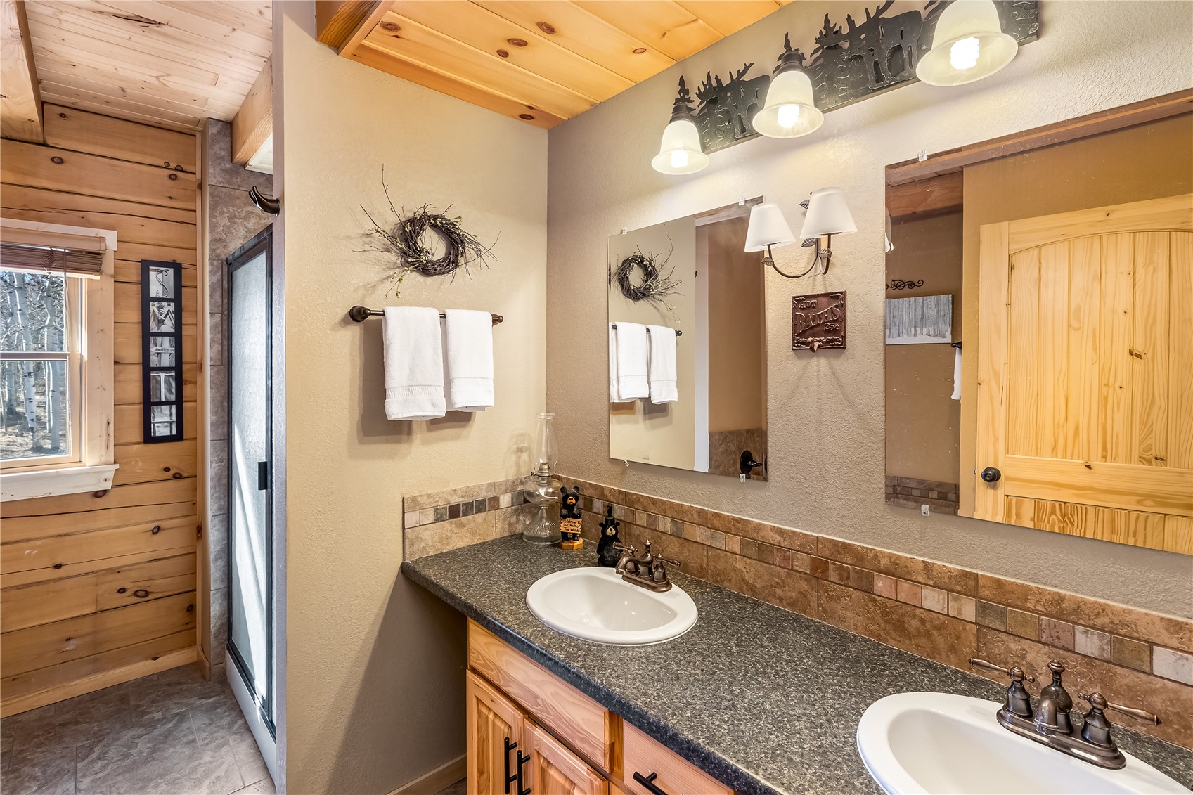 1059 Sheep Ridge Road Fairplay, CO 80440 - Photo 16 of 50 a bathroom with a granite countertop sink and a mirror