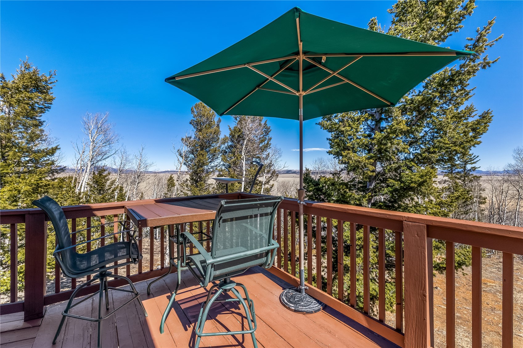 1059 Sheep Ridge Road Fairplay, CO 80440 - Photo 27 of 50 a view of a roof deck with table and chairs under an umbrella