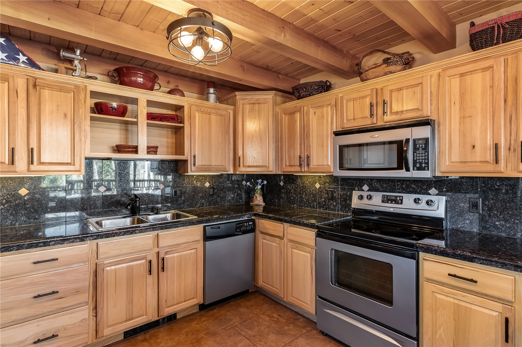 1059 Sheep Ridge Road Fairplay, CO 80440 - Photo 6 of 50 a kitchen with stainless steel appliances granite countertop a stove a microwave and wooden cabinets