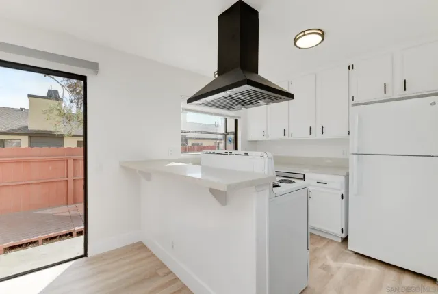 a kitchen with a sink and a refrigerator