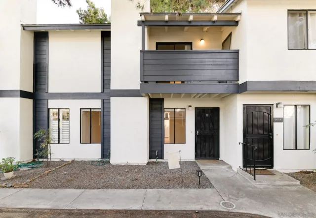 a view of a house with glass windows and door