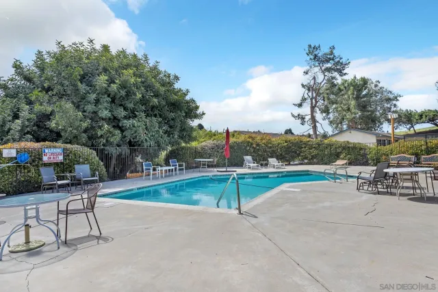 a view of backyard with seating area and green space
