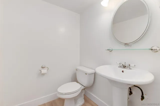 a bathroom with a sink a mirror and a toilet