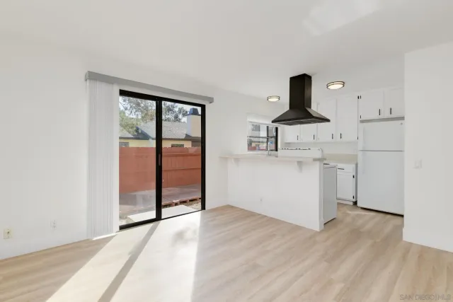 a view of a kitchen with a sink cabinets and wooden floor