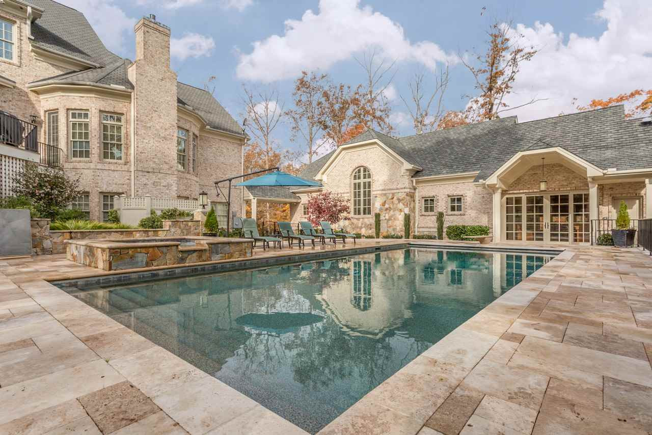 3032 Cone Manor Lane Raleigh, NC 27613 - Photo 4 of 30 The inviting pool is accessible from the screen porch, deck, basement recreation room, and the detached luxury garage suite. Another large section of the backyard is also fenced and is perfect for fun and games as well as a place for pets to play. Inviting Poolside Setting
